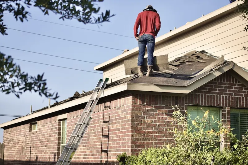 Professional roofer working on a residential roof in Kings Village